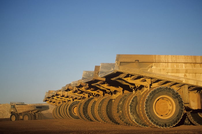 Download Whitepaper Ore hauling trucks in row Telfer Western Australia