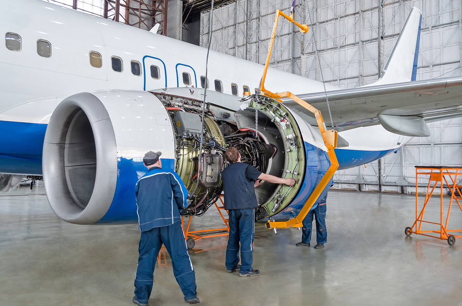 Aviation Maintenance crew repairing aircraft engine